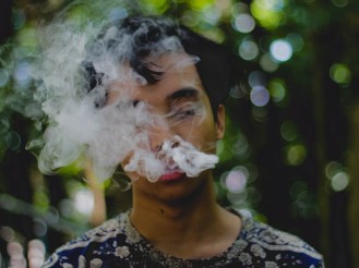 person exhaling smoke